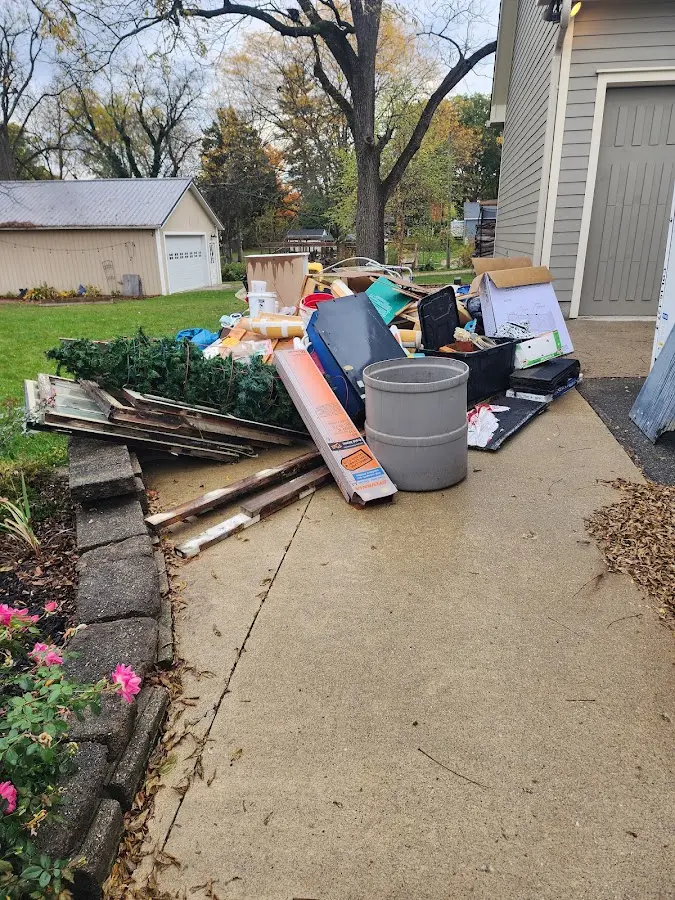 Dumpster being loaded with debris for Residential Dumpster Rental in Redan